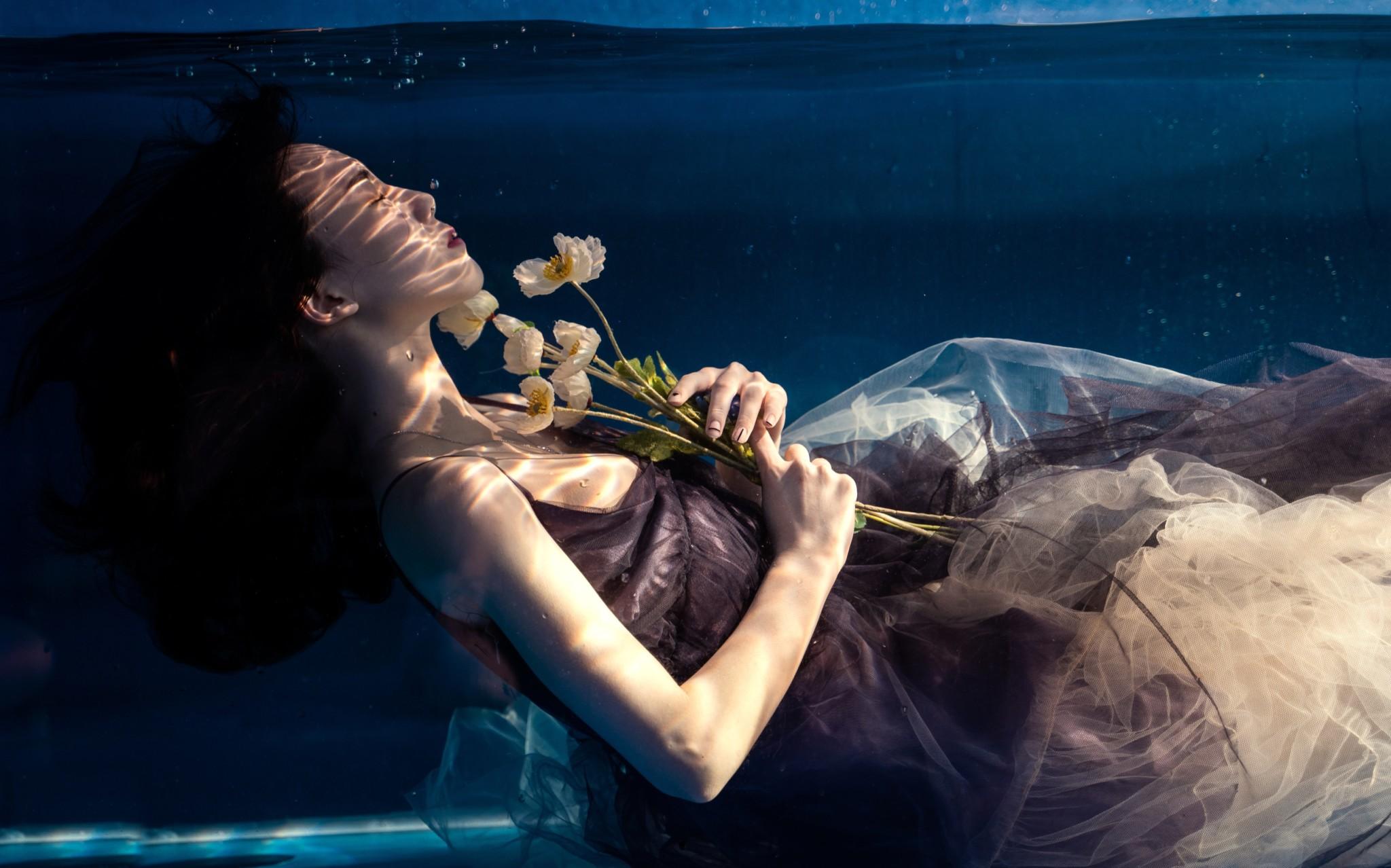 A submerged woman holding white flowers, published in the Misread feature